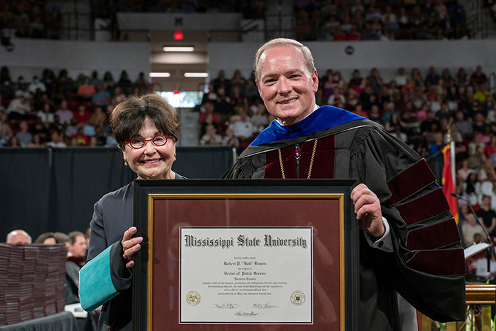 Sheryl Bowen accepts an honorary Doctor of Public Service degree on behalf of her husband