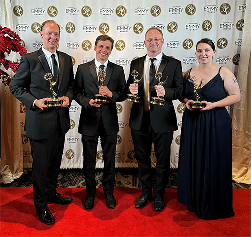 Staff pictured with multiple Emmy Awards