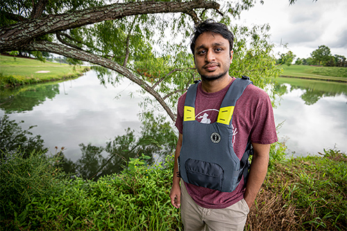 Amit Talukder poses in a life jacket prototype