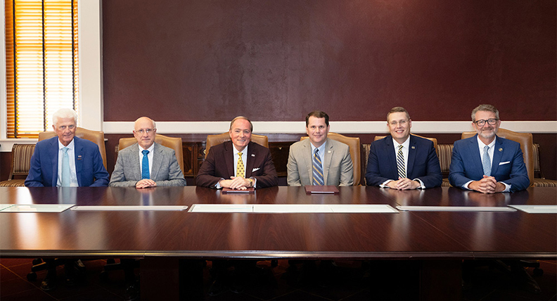 MSU and MC officials seated at conference room table