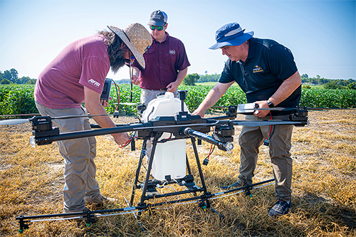 Personnel ready a spray drone